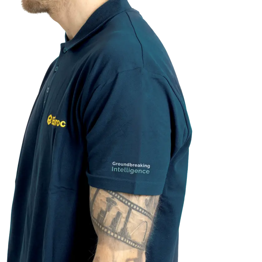 Grey polo with ground logo on left arm